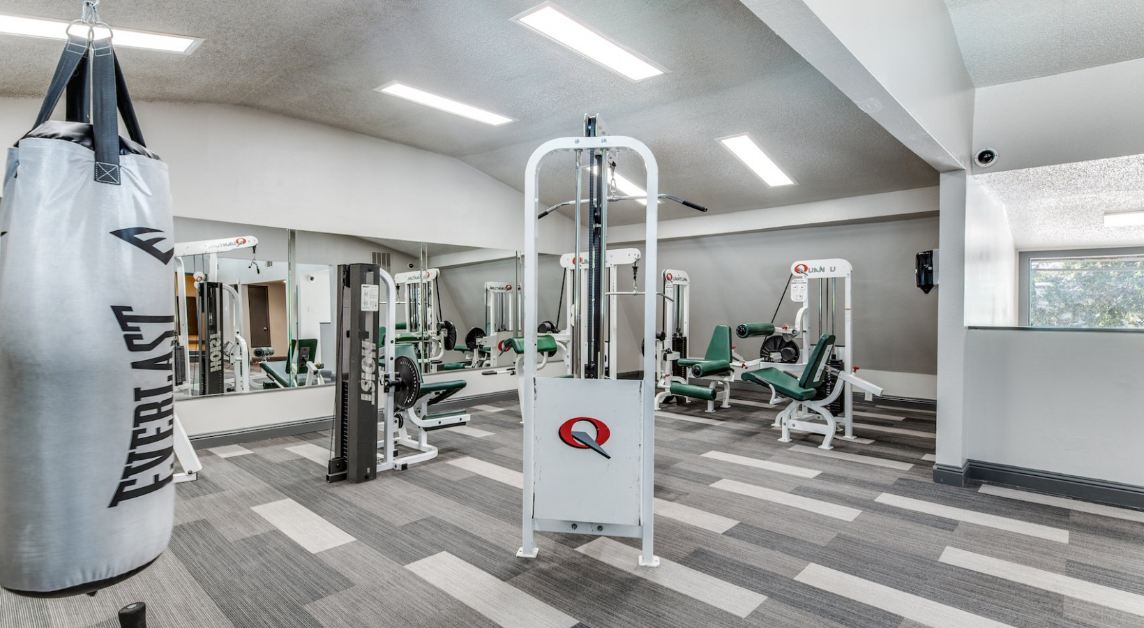 a gym room with a punching bag and weights at The 8500 Harwood