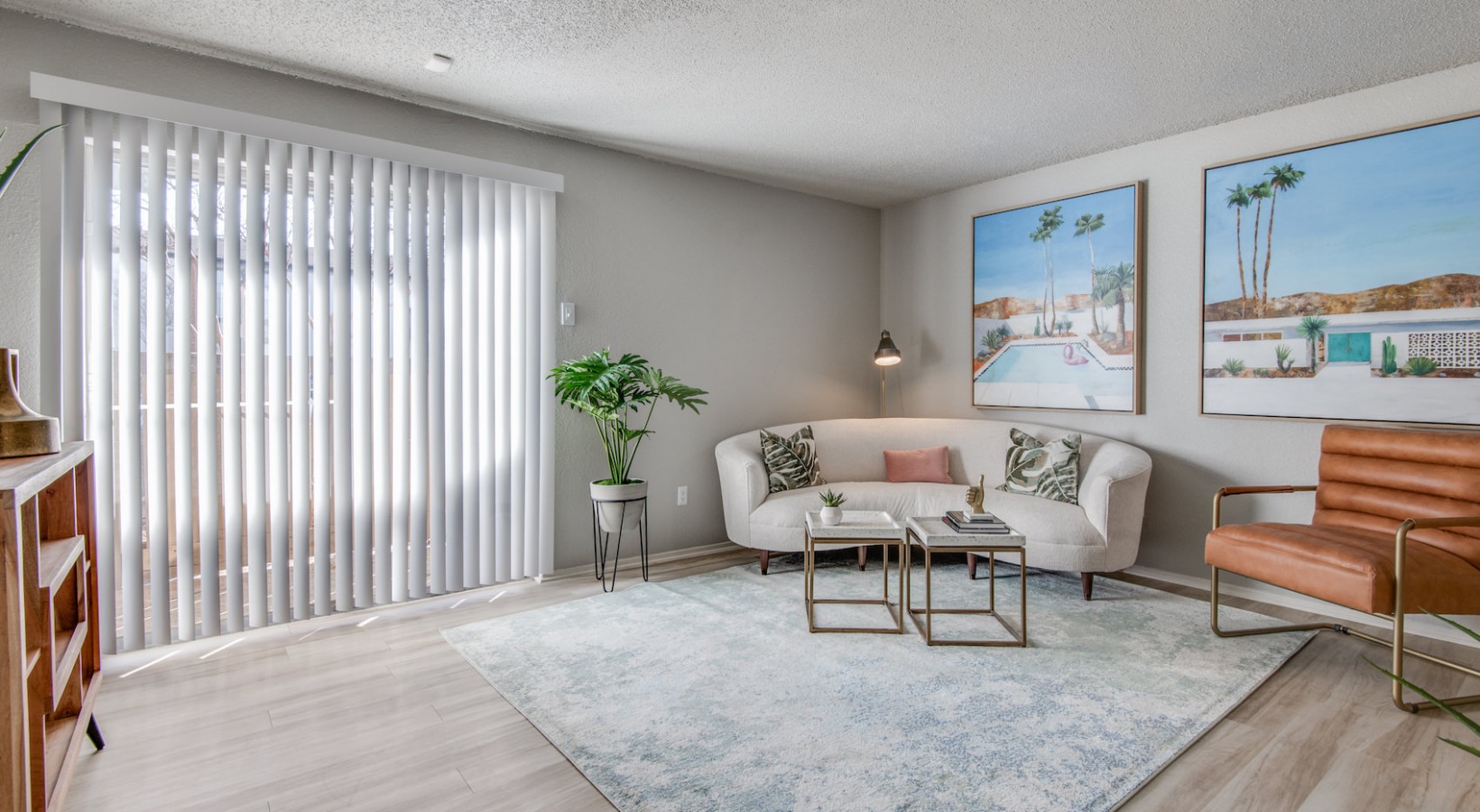 a living room with white walls and a large window at The 8500 Harwood