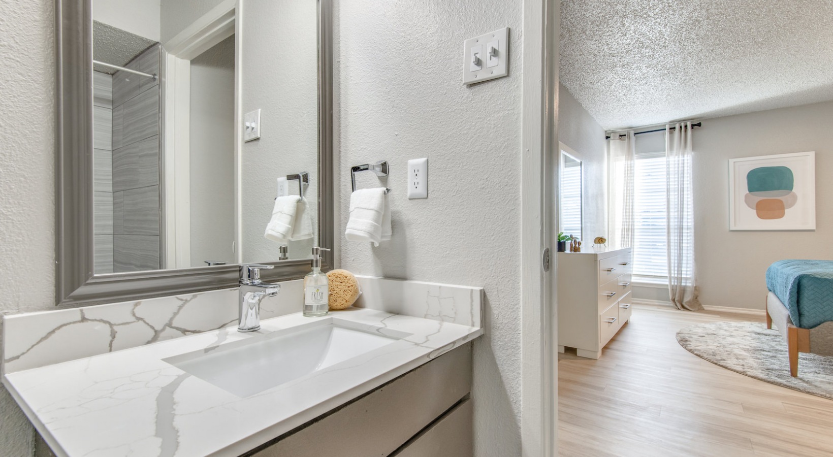 a bathroom with a sink, mirror and toilet at The 8500 Harwood